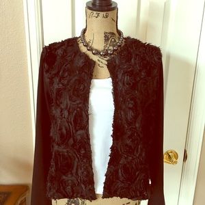 Textured front dressy black jacket.